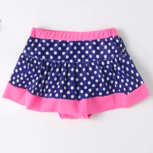 Polka dot navy blue and pink girls' swim skirt with ruffled layers for sun protection