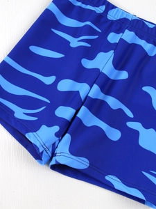Detail of boys' navy camouflage swim trunks featuring quick-dry fabric and flatlock seams