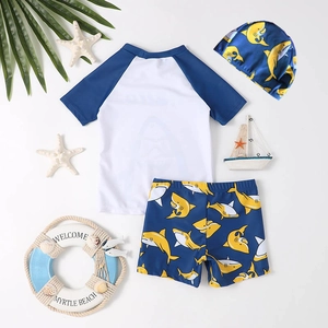 Boy's 3-piece swimwear set with blue short-sleeved top and shark print shorts and cap