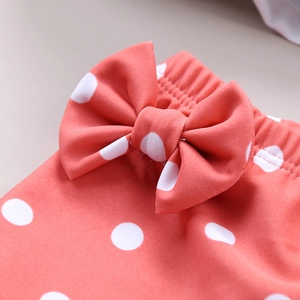 Close-up of girls' polka dot swimwear with a large bow and elastic waist detail