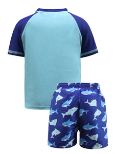 Detailed flat lay of boys two-piece swimsuit with shark print shorts and short sleeves
