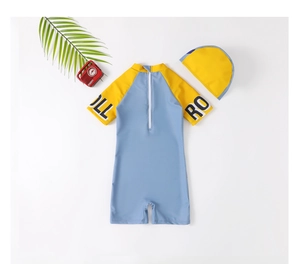 Flat lay of blue and yellow kids one-piece swimsuit with matching swim cap and back zipper