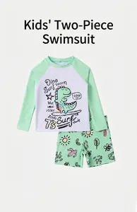 Flat lay of boys long sleeve surfing swimsuit with cartoon dino and matching trunks
