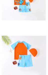 Three-piece boys' swimwear set with orange dinosaur swim shirt, blue shorts and cap