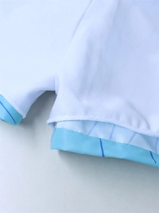 Macro detail of breathable white mesh fabric with blue striped lining on kids swimwear