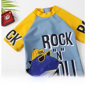 Detail of cartoon dinosaur print and vibrant color-block stitching on kids swimwear