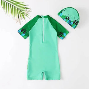 Boys short sleeve one-piece swimsuit with tropical leaf print and matching swim cap