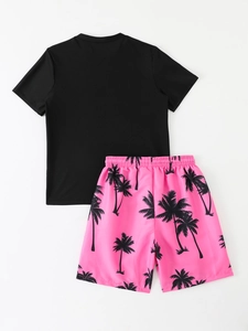 Detail of kids quick-dry swimwear featuring black t-shirt and pink palm tree shorts