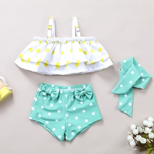 Three-piece girls' polka dot swimsuit with ruffled top, mint green bottoms and headband