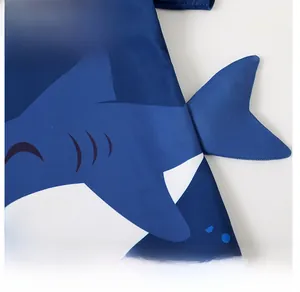 Detail shot of 3D fin design on blue shark-themed kids' swimwear with Summer print