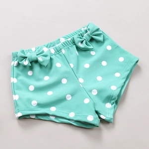 Mint green polka dot girls swimwear bottom with sweet bow details and ruffled edges