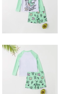 Detail of boys long sleeve swimsuit set with cartoon dinosaur surfing print and palm patterns