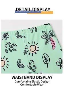 Detail of mint green boys swim shorts with sun and palm tree tropical print