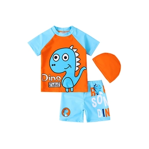 Three-piece kids dinosaur swimwear set with orange short-sleeve top and blue swim cap