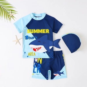 Three-piece boys' swimsuit set featuring a cartoon shark print and a matching swim cap