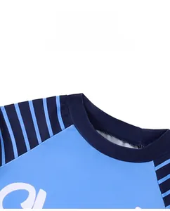 Close-up detail of the round neckline and blue striped long sleeves on boys swimwear
