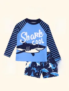 Detail of boys' shark print swimwear with elastic fabric and long sleeve sun protection