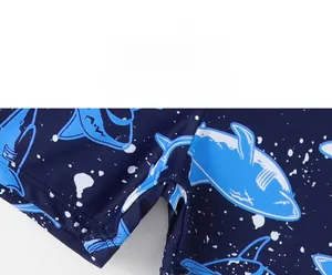Detail of boys shark print swimsuit leg opening with durable stitching and navy fabric