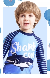 Detailed view of the boys' long-sleeve swimwear featuring a shark print and blue stripes