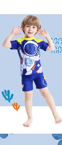 Detail view of boys' two-piece swimsuit with cartoon astronaut print and yellow trim