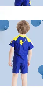 Rear view of two-piece boys swimsuit with navy and yellow contrast and star print