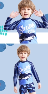 Detail of boys' two-piece swimsuit featuring shark print and striped long sleeves