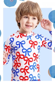 Close-up of kids long sleeve swimsuit with red and blue bow print and elastic fabric