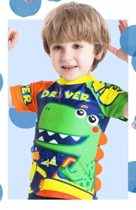 Detail of short sleeve boys swimwear with cartoon dinosaur print and vibrant color blocks
