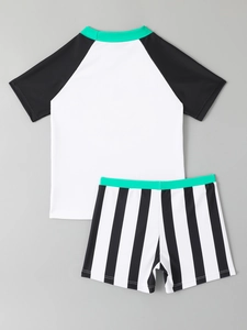 Flat lay of boy's two-piece swimwear with raglan sleeves and striped shorts set