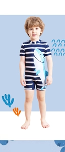 Detail of boys' navy striped swimsuit with cartoon shark and 3D fin accent