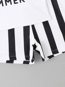 Detail of boys' swimwear showing the elastic waist and striped quick-dry fabric texture