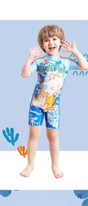 Detail of cartoon dinosaur print and orange stitching on blue boy swimming suit