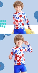 Detail of boys long sleeve swimsuit with red bow print and blue swim shorts