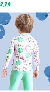 Rear view of long-sleeve kids swimsuit with cartoon dinosaur prints and green pants
