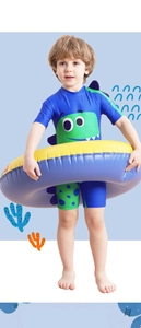 Detail of boys' one-piece swimsuit with cartoon dinosaur print and blue swim ring