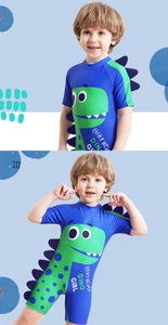Detail of blue dinosaur kids swimsuit with 3D purple scales and cartoon print