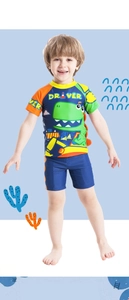 Close-up of boys dinosaur and driver print swim set with vibrant color block design