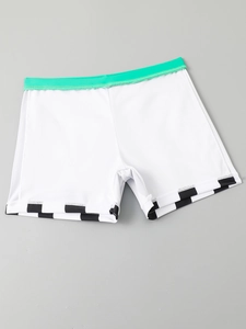 Detail of boys' swim shorts featuring green elastic waistband and checkerboard hem prints