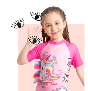 Detail view of pink girls swimsuit featuring unicorn print and colorful ruffled trim