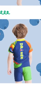 Back view of boys' blue swim shirt with cartoon green dinosaur print and driver text