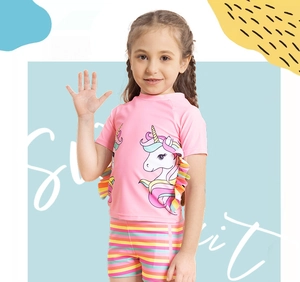 Detail of girls' two-piece swimsuit with unicorn print and rainbow ruffle trimmings