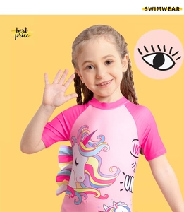 Close-up of rainbow unicorn print on girls' short sleeve pink one-piece swimsuit