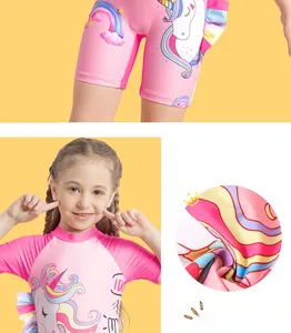 Detail of pink girls' swimwear showing unicorn print and ruffled edges on stretch fabric