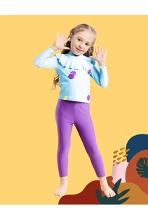 Detail of girls long-sleeve swimwear featuring ruffles and purple cherry print pattern
