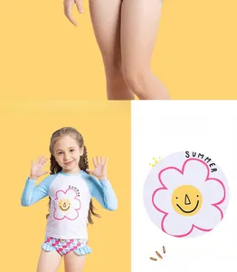 Detail of girls floral two-piece swimwear with long sleeves and summer smile pattern