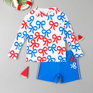 Two-piece boys long sleeve swimsuit with red bow print and blue swim shorts for summer