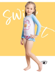 Detail of girls two-piece long sleeve swimsuit with sunflower print and ruffled bikini bottoms