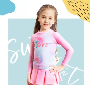 Detail of pink tie-dye long sleeve rash guard with LOVE print and pleated swim skirt