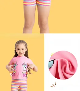 Detail of girls two-piece swimsuit with unicorn print and rainbow ruffle sleeves