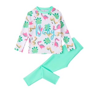 Two-piece boys long sleeve swimsuit with colorful dinosaur prints and mint green pants